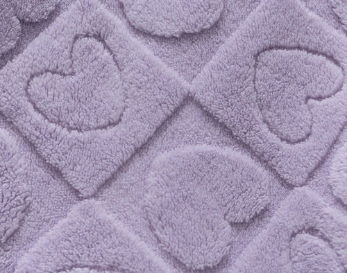 Close up of the Etched Hearts Fleece Throw, showing the plush surface and textural design.