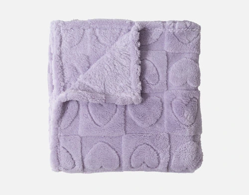 The Etched Hearts Fleece Throw, folded into a square with a corner folded down.