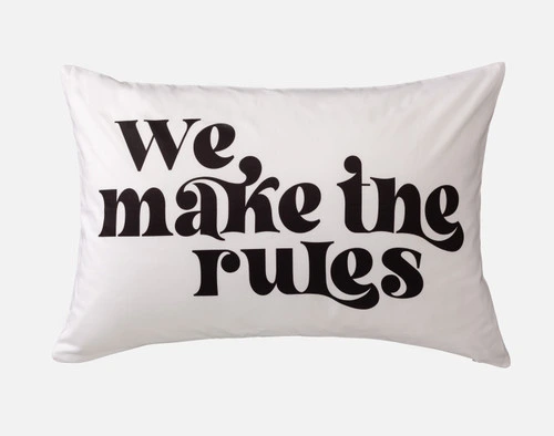 Front view of a pillowcase reading "We make the rules" in large black font over a white surface.