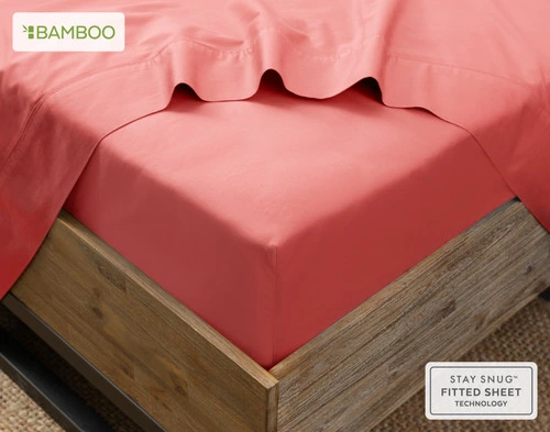 Angled view of our Bamboo Cotton Fitted Sheet in Huckleberry, a bright rosy red, snugly wrapped around a mattress.