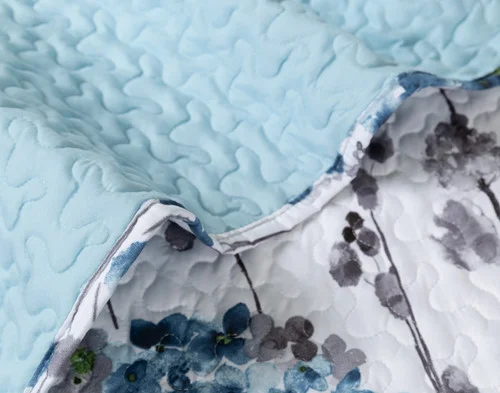 Close-up on the solid backing and botanical surface on our Marisol Coverlet Set.