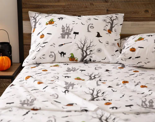 Front view of a pillowcase and the flat sheet of our Haunted House Cotton Percale Sheet Set.