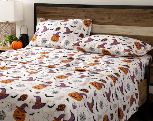 Angled view of an empty queen bed dressed in our Hallows Eve Cotton Percale Sheet Set.