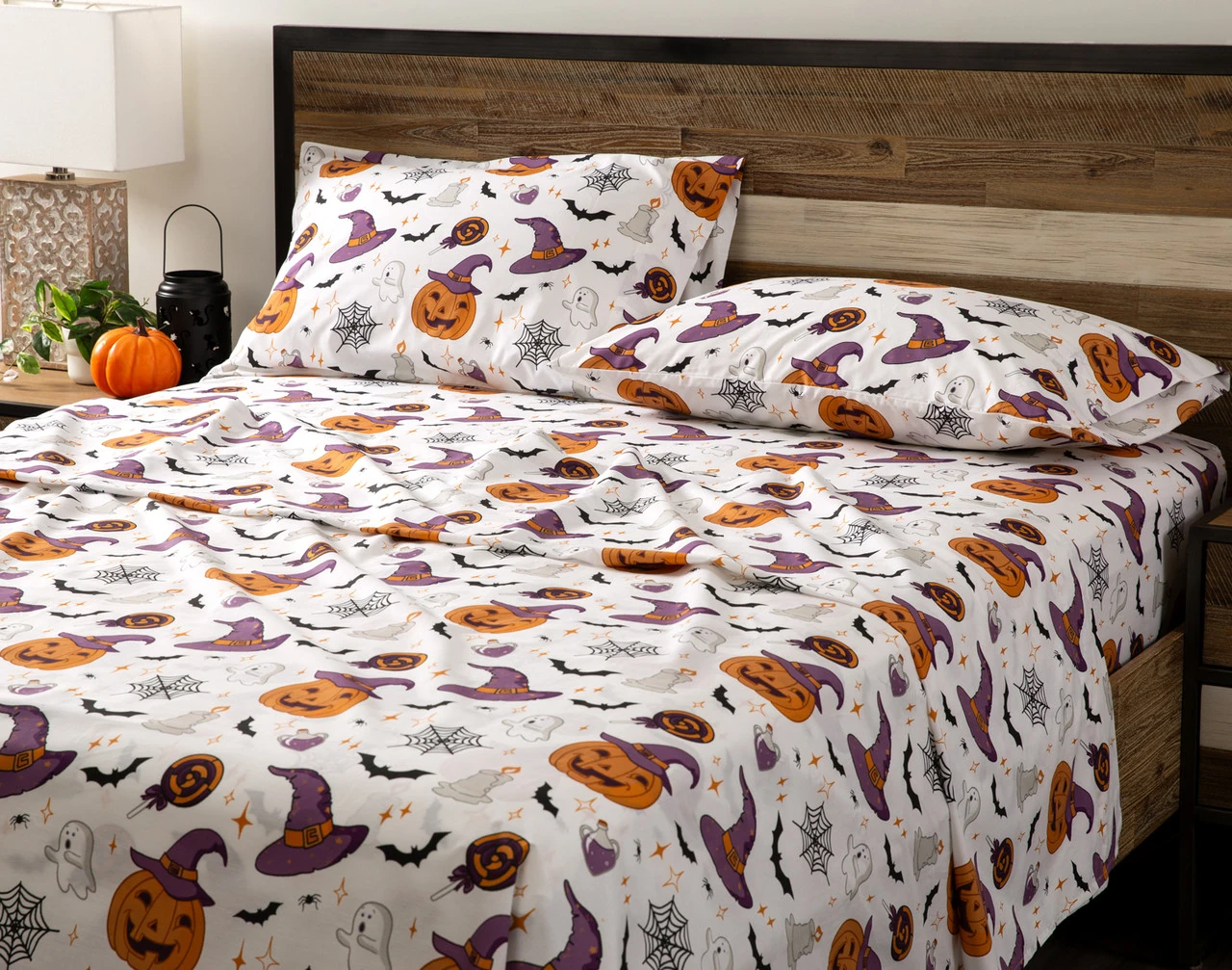 Angled view of an empty queen bed dressed in our Hallows Eve Cotton Percale Sheet Set.