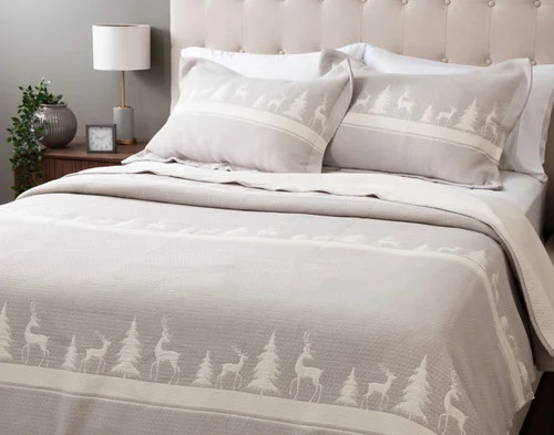 Angled view of our Deer Trail Cotton Quilt Set dressing a queen bed in a Canadian bedroom.
