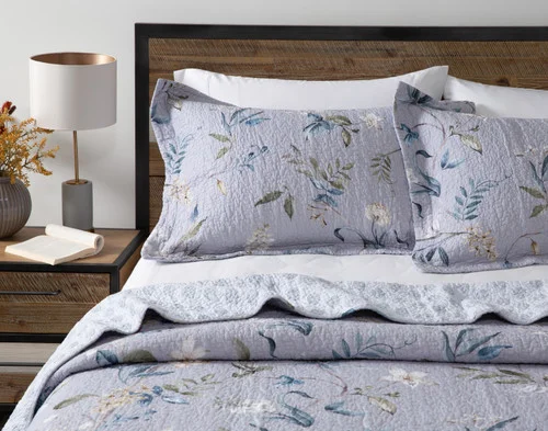 Off-centre view of our Sara Cotton Quilt Set dressing a queen bed in a minimalist, modern room.