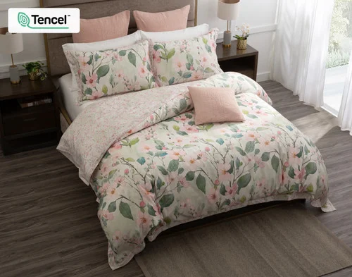 Top-down shot of our Enamour Duvet Cover with pink accessories.