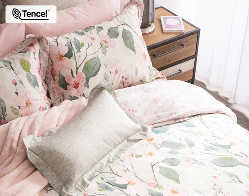 Our Enamour collection dressing the head of a bed with pink accessories.