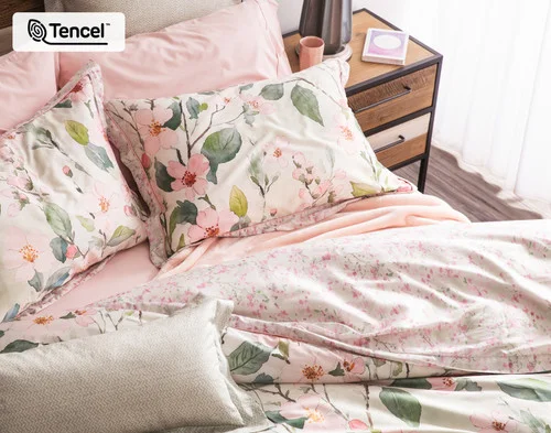 Our Enamour collection dressing the head of a bed with pink accessories.