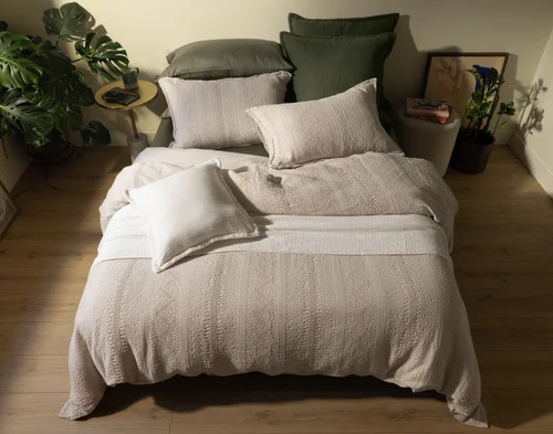 Top-down view of our Rustico collections dressing a bed with green sheeting.