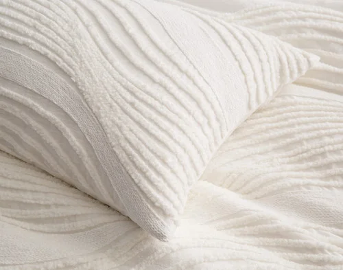 Close up on our Savary Pillow Sham atop our Savary Duvet Cover.