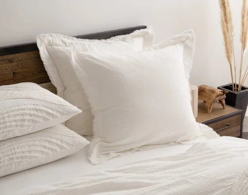 Angled view of our Savary Euro Shams dressing the head of a bed with our Savary collection.