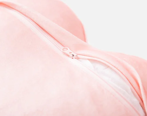 Close-up on the zipper enclosure on the back of our All Mine Candy Heart Cushion.