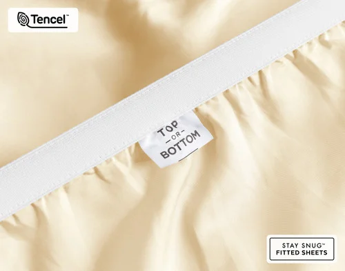 Close-up of Top & Bottom tag on the elastic of our BeechBliss TENCEL™ Modal Fitted Sheet in Cornsilk.