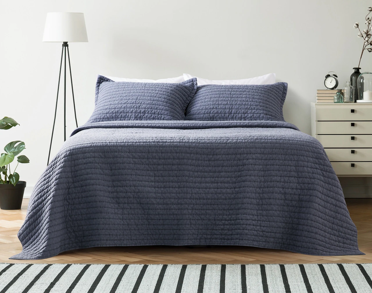 Front view of our Anchorage Quilt Set dressed over a white queen bed.