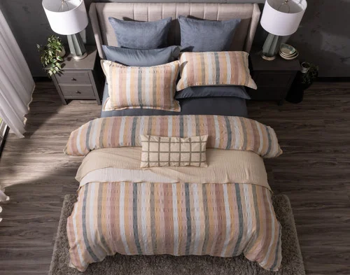 Top-down view of our Carmen collection dressing a bed with dark blue accessories.