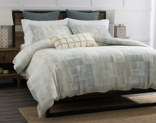 Angled view of our Palette Duvet Cover over a plain queen bed.