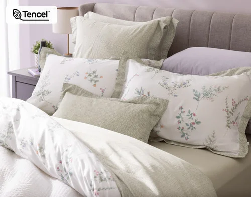 Our Annika Boudoir Pillow Cover with our Annika collection and accessories at the head of a bed.