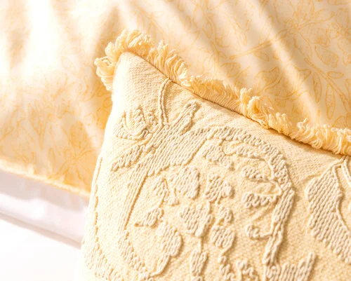 Close view of the corner of our Oriana Boudoir Pillow Cover with its matching euro sham in the background.