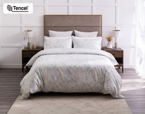Front view of our Josephine Duvet Cover dressing a queen bed in a modern white room.