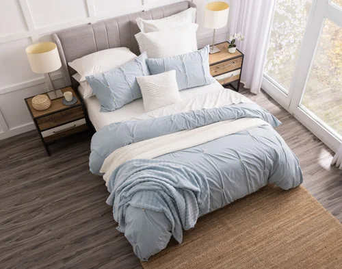 Angled, top-down view of our Clio collection dressing a bed with white accessories.