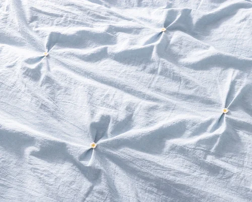 Close up on the pinched surface of our Clio Duvet Cover Set.