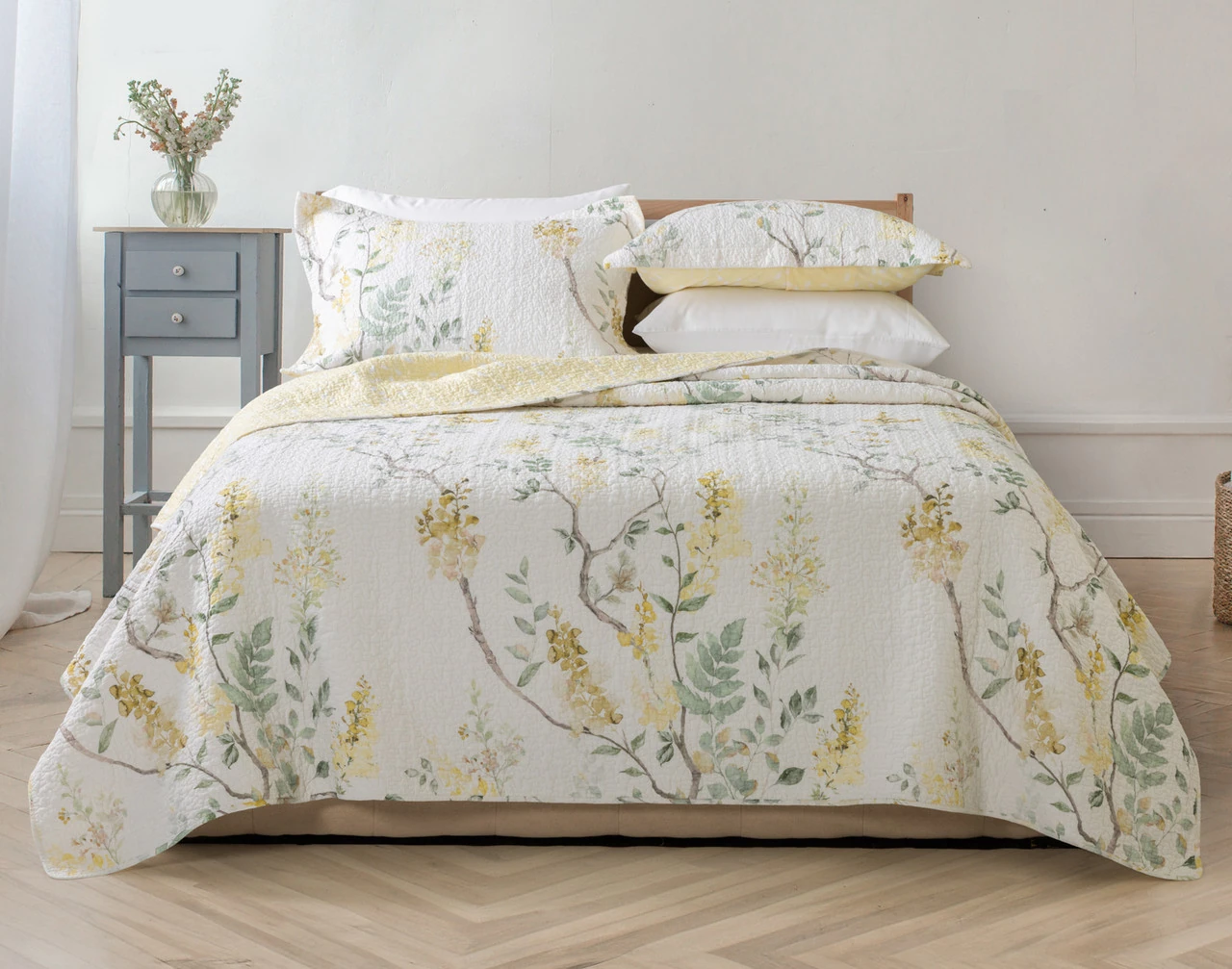 Front view of our Florian Quilt Set dressed over a plain queen bed.