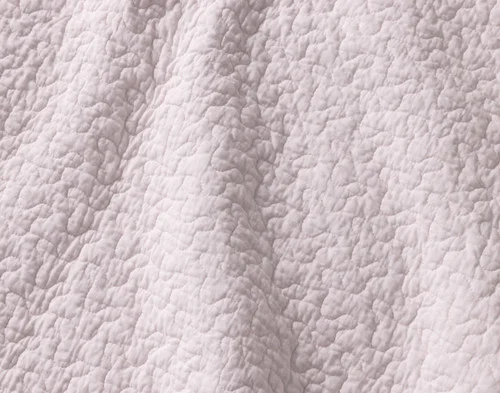 Close-up of the solid pink reverse on our Blossom Cotton Quilt Set.