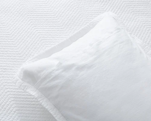 Reverse view of a pillow sham from our White Hermosa Quilt Set.