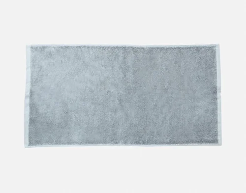 Our Blue Dusk Modal Cotton Bath Towel sitting flat on a white backdrop.