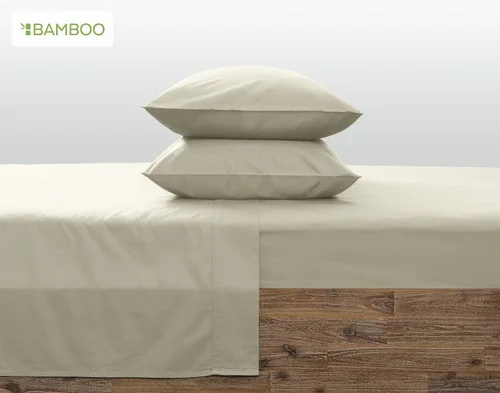 Our Bamboo Cotton Pillowcases in Thyme resting symmetrically on a wooden bed.