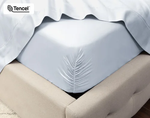 Close-up on the corner of a mattress with our Eucalyptus Luxe TENCEL™ Lyocell Fitted Sheet in Blue Chalk to show its snug fit.