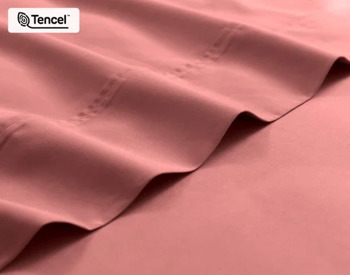 Close-up on the edge of the flat sheet for our Eucalyptus Luxe TENCEL™ Lyocell Sheet Set in Raspberry Ice.