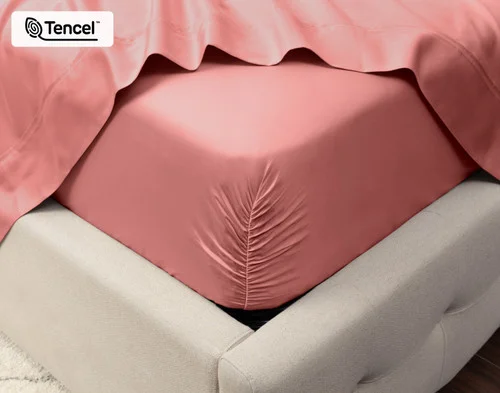 Close-up on the corner of a mattress with our Eucalyptus Luxe TENCEL™ Lyocell Fitted Sheet in Raspberry Ice to show its snug fit.