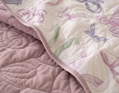 Folded edge on our Bowknots Quilt Set to show its velvet surface and cotton reverse.