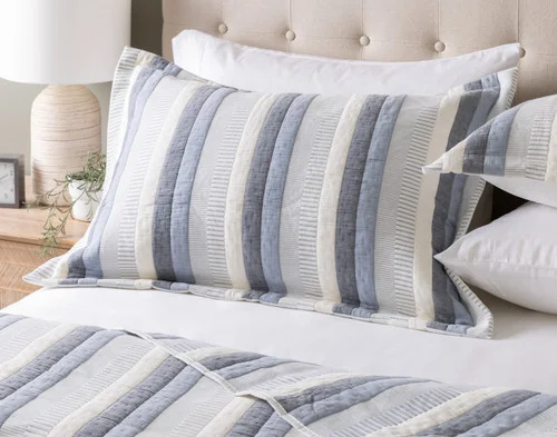 Our Piers Cotton Pillow Sham at the head of a bed.
