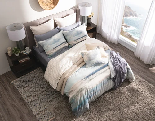 Angled view of our Windswept Duvet Cover with accessories in a stylish room.