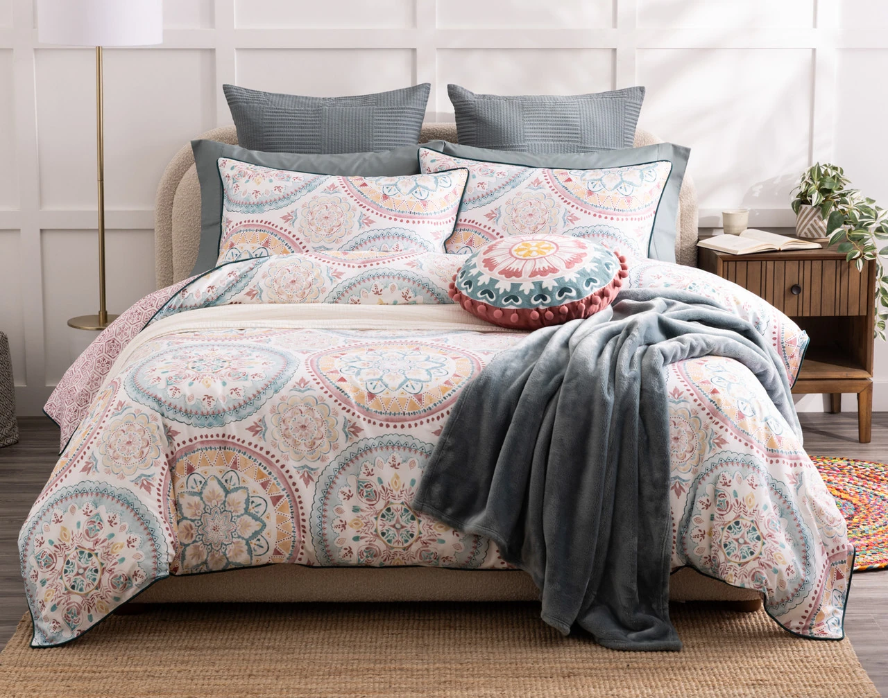 Top-angled view of our Mandira Duvet Cover Set dressing a queen bed with pink accessories.