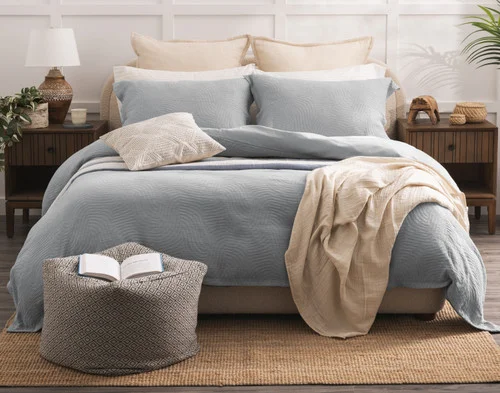 Front view of our Cielo Duvet Cover Set dressing a queen bed with orange accessories.