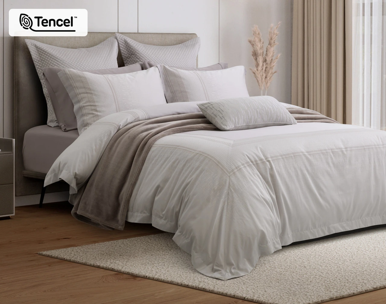 Angled view of our Renley Duvet Cover dressing a queen bed with accessories.