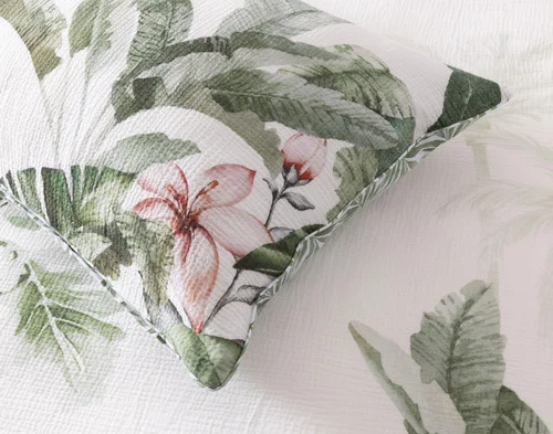 Angled, close view of our Sail Away Pillow Sham atop our Sail Away Duvet Cover.