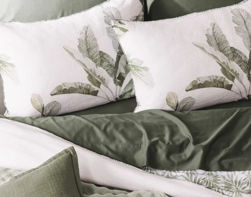 Our Sail Away Pillow Shams dressing the head of a bed with green accessories.