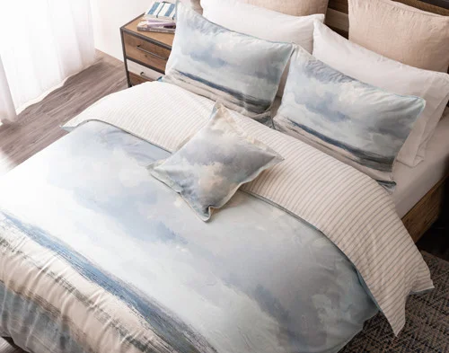 A bed dressed in our Windswept Duvet Cover, Pillow Shams, and Square Cushion Cover.