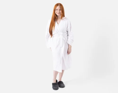 Front view of a woman wearing our Bamboo Cotton Gauze Bathrobe in White.