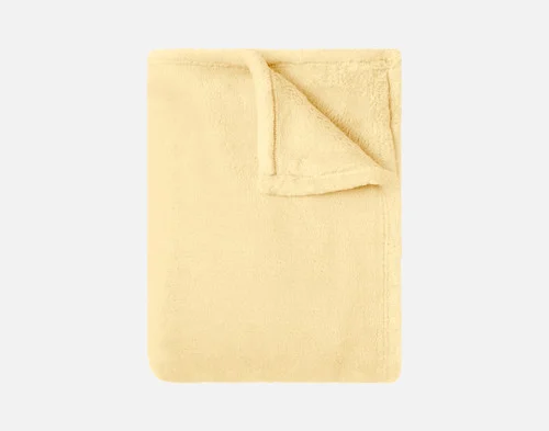 Our Velvet Plush Throw in Lemon Ice folded neatly into a tidy square.
