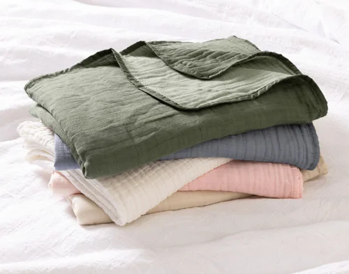 A pile of our Bamboo Gauze Throws in all their colours.