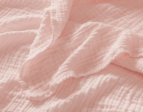 Close up on the textured surface of our Bamboo Gauze Throw in Blossom.