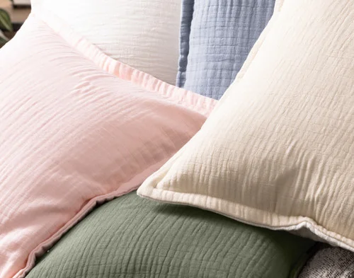 Close up on our Bamboo Gauze Square Cushion Covers in a pile.