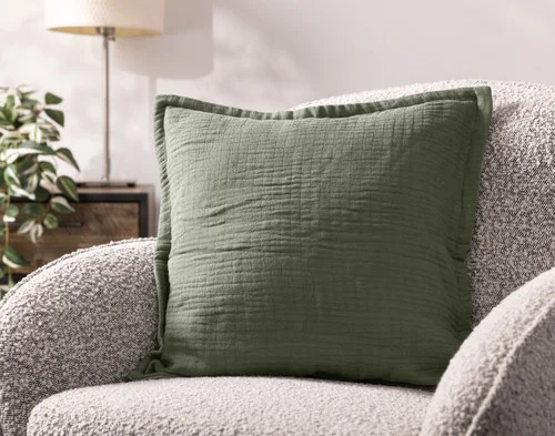 Our Bamboo Gauze Square Cushion Cover in Leaf on a grey chair.