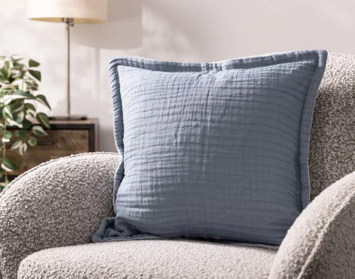 Our Bamboo Gauze Square Cushion Cover in Seaside on a grey chair.